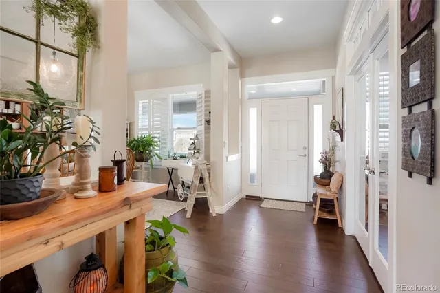 a kitchen with stainless steel appliances kitchen island granite countertop a refrigerator a oven a sink with island and chairs