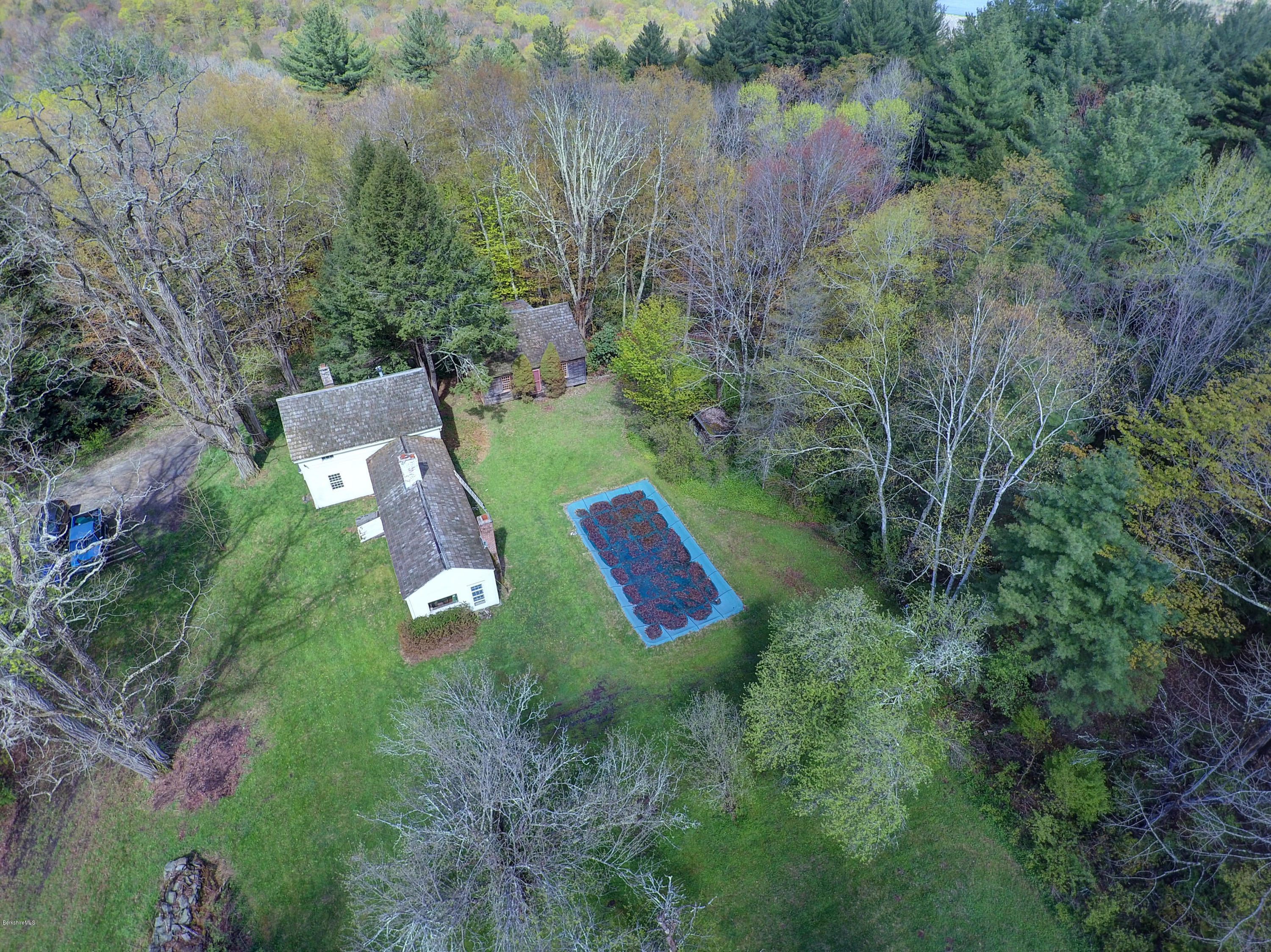 82 Hammertown Road Sandisfield, MA 01255 - Photo 22 of 49 a view of a lake with a house and a yard