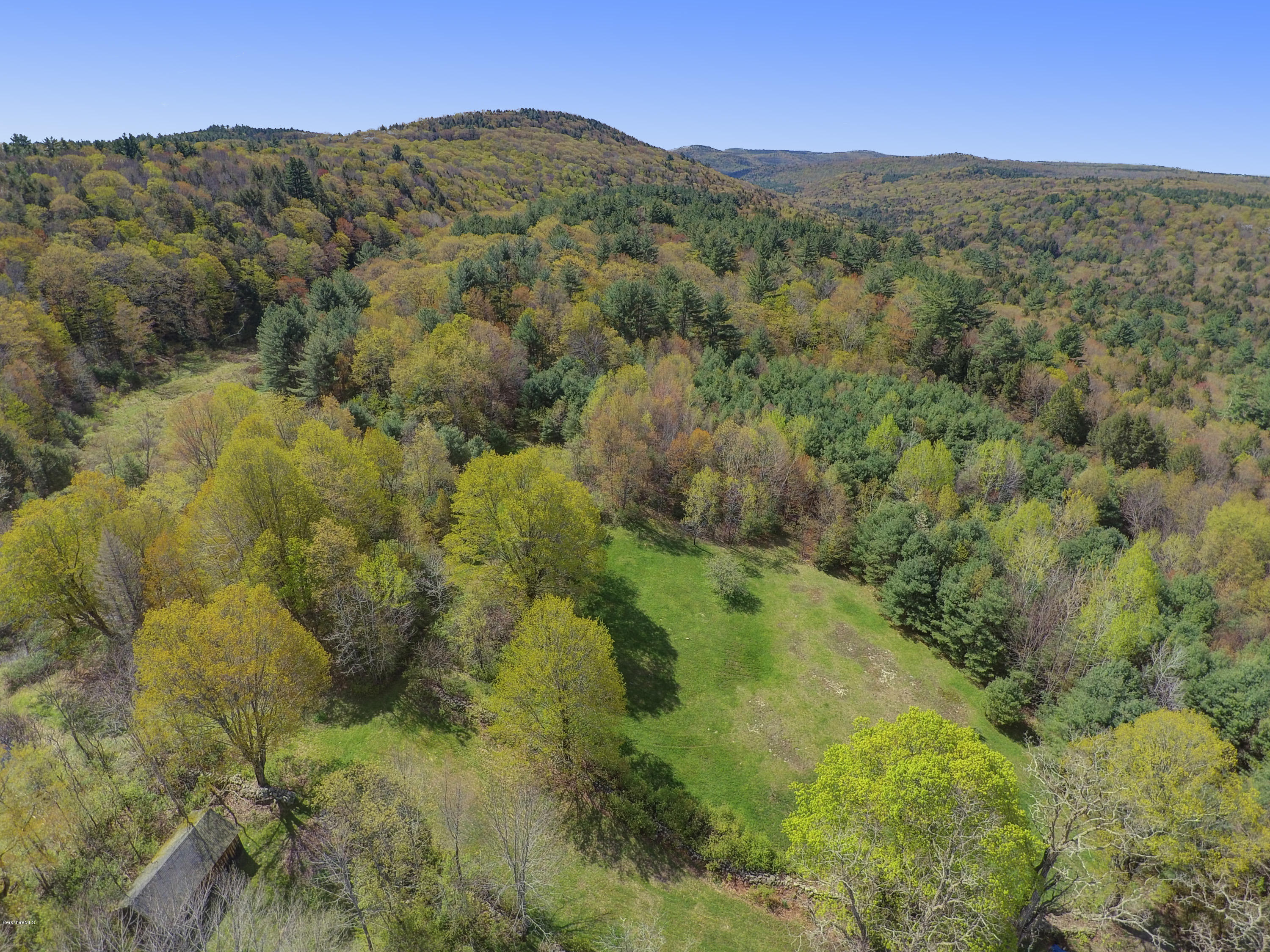 82 Hammertown Road Sandisfield, MA 01255 - Photo 26 of 49 a view of a lush green hillside and a mountain