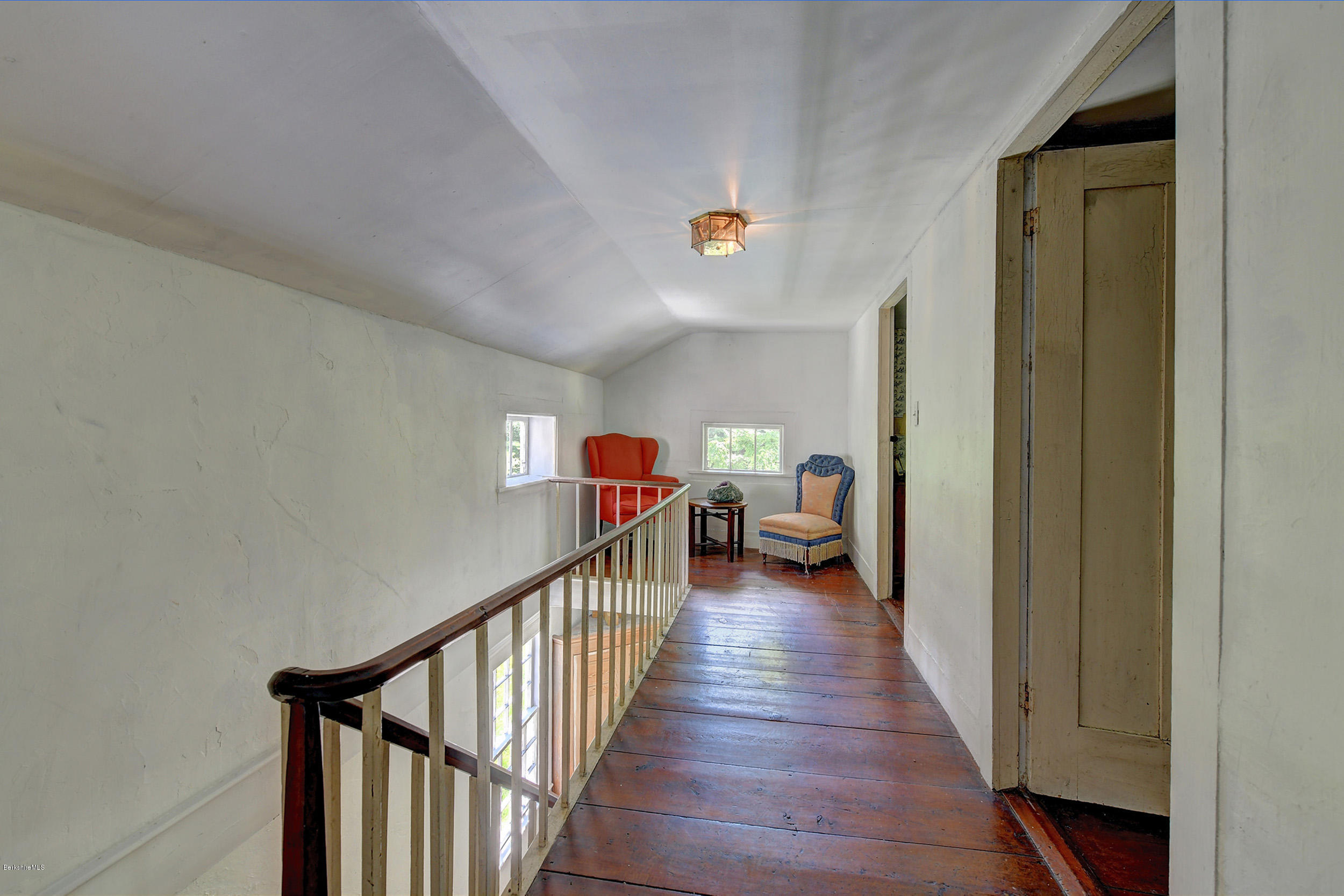 82 Hammertown Road Sandisfield, MA 01255 - Photo 34 of 49 a view of a hallway to a livingroom with wooden floor and stairs