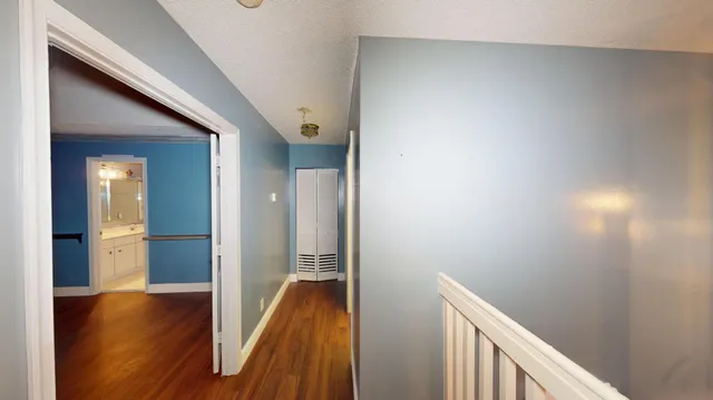 a view of hallway with wooden floor