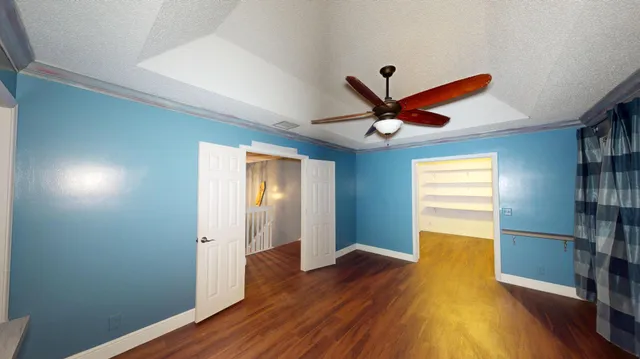 a view of room with window ceiling fan and hardwood floor