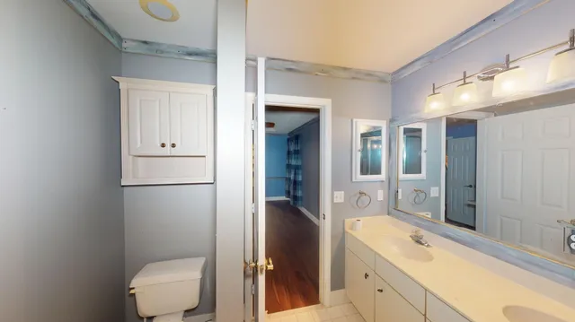 a spacious bathroom with a granite countertop sink toilet and shower