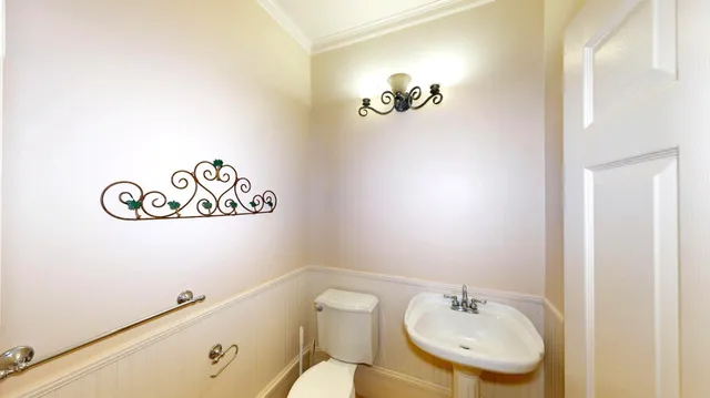 a bathroom with a sink a mirror and a toilet