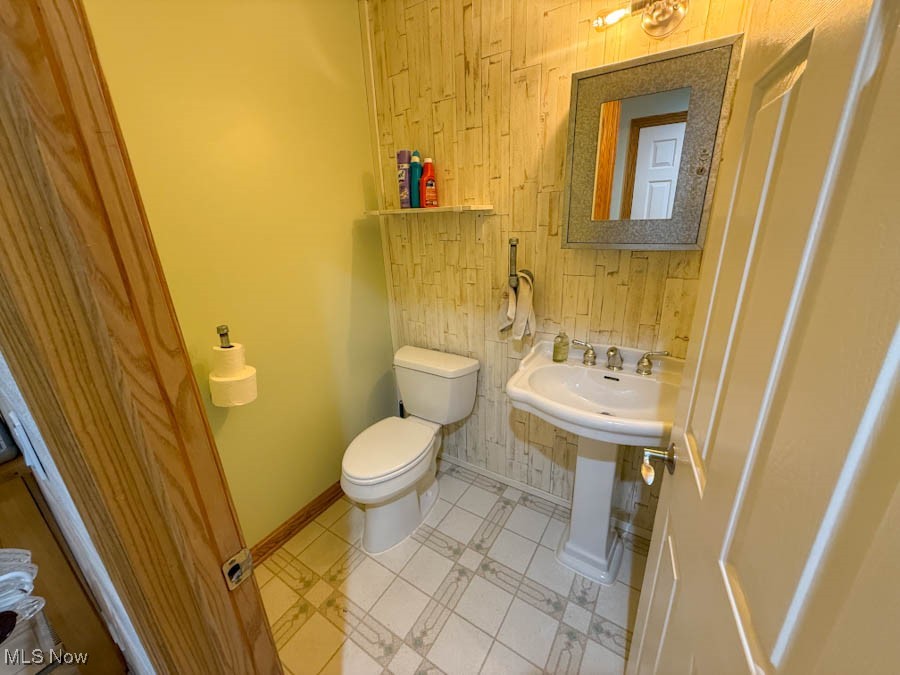 15990 Old State Road Middlefield, OH 44062 - Photo 12 of 24 Half bath with wood walls and light tile patterned floors