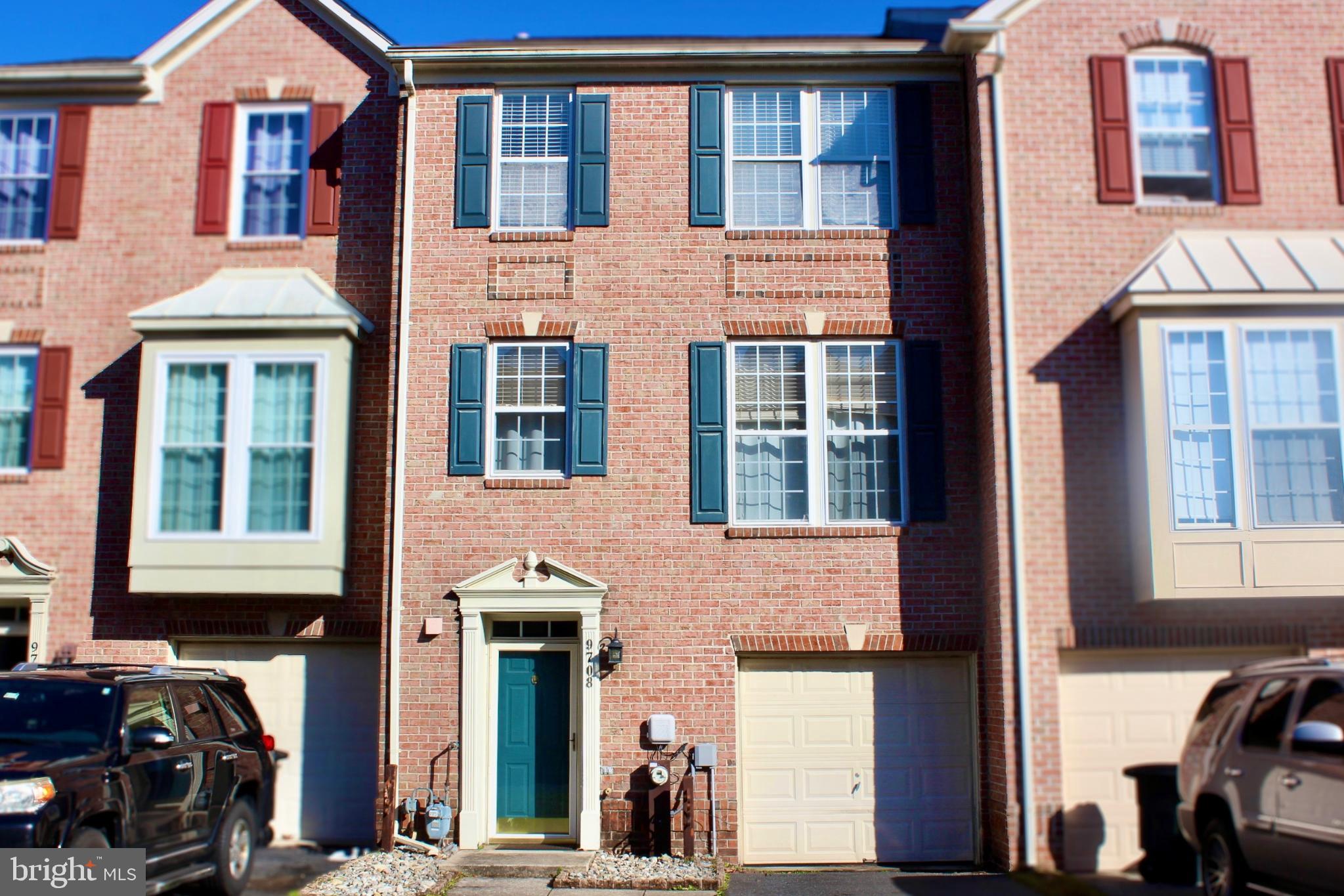 Charming brick townhouse with classic shutters.