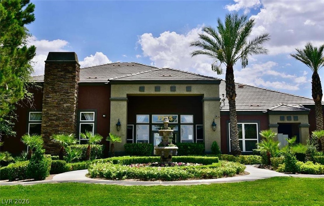 7255 West Sunset Road, Unit 2023 Las Vegas, NV 89113 - Photo 1 of 24 A grand stone chimney and manicured circular walkway frame this impressive modern facade.