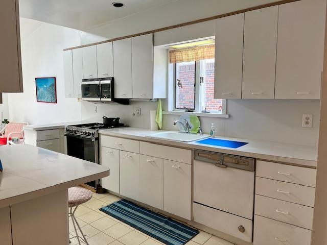 2955 Avenue P Brooklyn, NY 11229 - Photo 12 of 22 a kitchen with white cabinets and white appliances