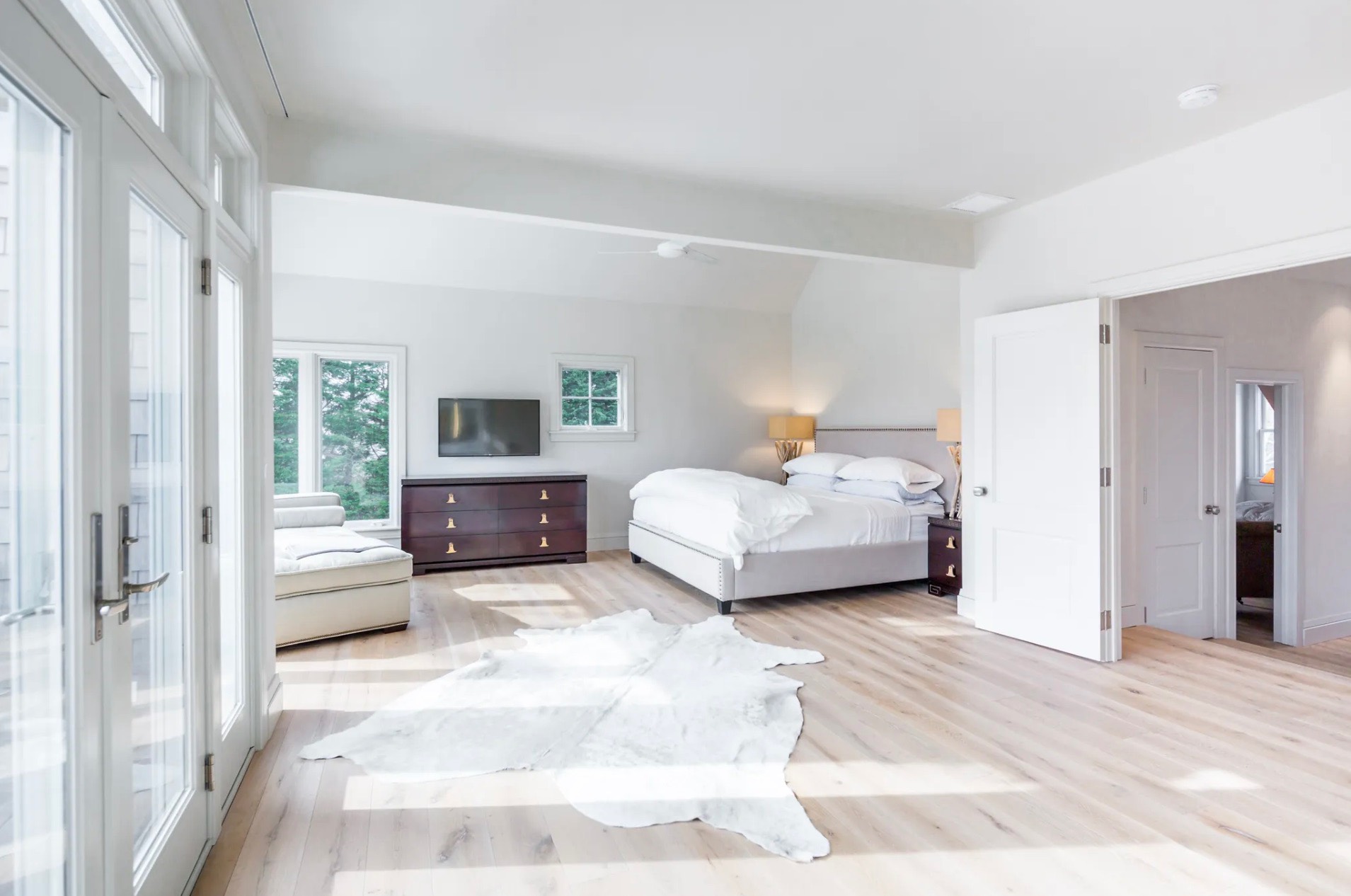 198 Herrick Road Southampton, NY 11968 - Photo 17 of 23 a bedroom with a large bed and a couch
