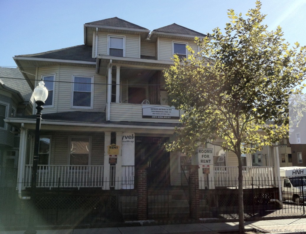 1458 East Main Street, Unit 23 Bridgeport, CT 06608 - Photo 1 of 1 a view of a house with a tree