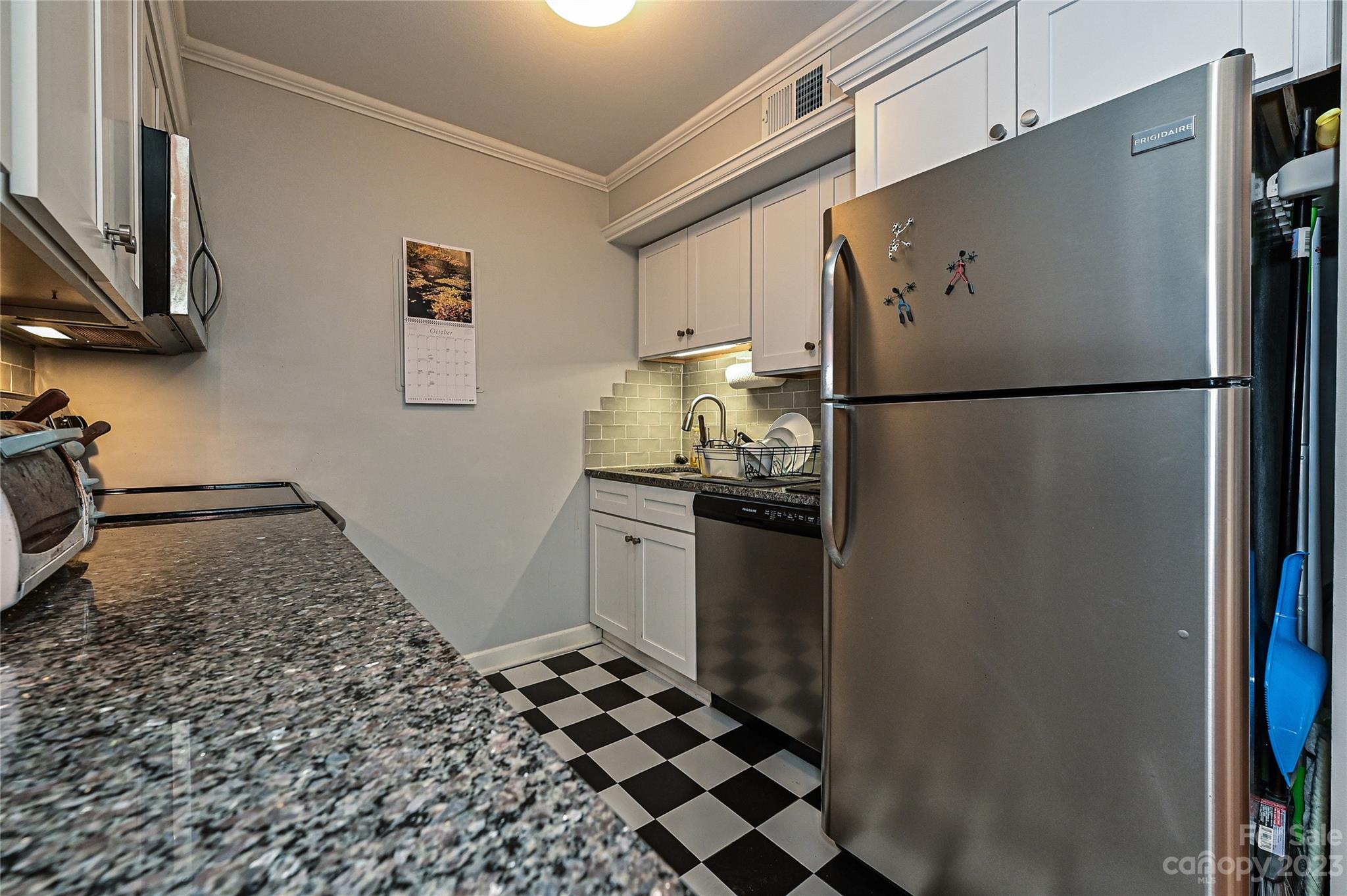 400 Queens Road, Unit B5 Charlotte, NC 28207 - Photo 11 of 20 a kitchen with a refrigerator and a stove top oven