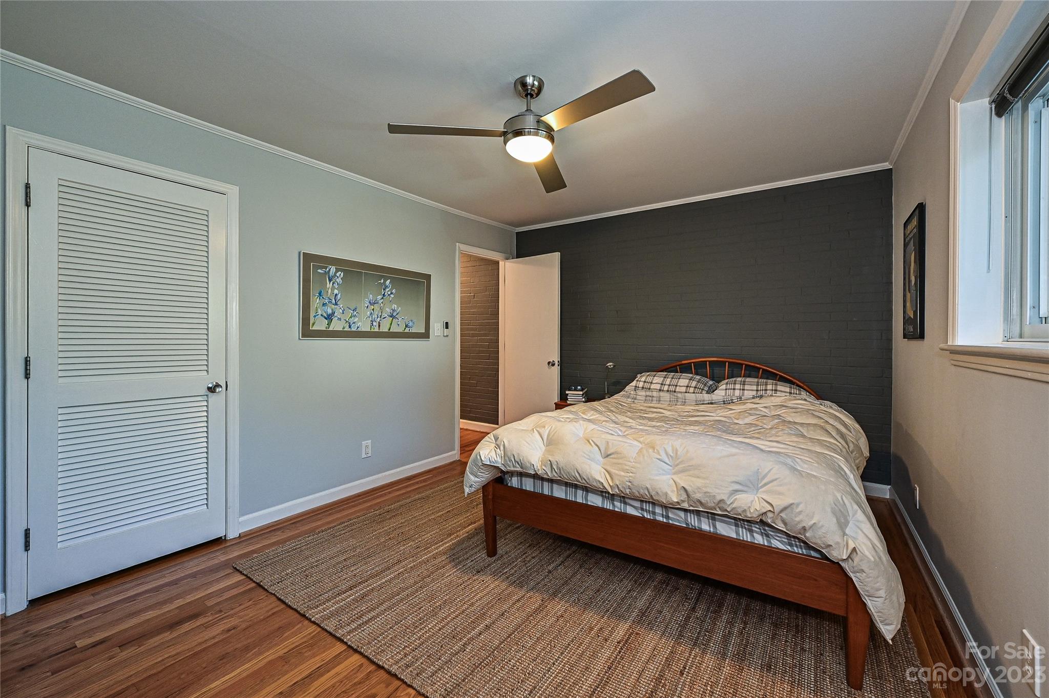 400 Queens Road, Unit B5 Charlotte, NC 28207 - Photo 16 of 20 a bedroom with a bed and wooden floor