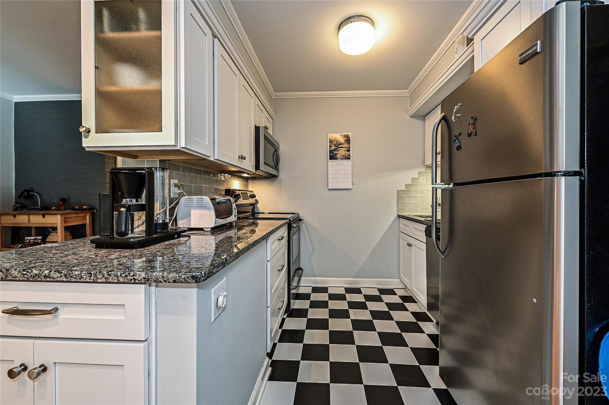 400 Queens Road, Unit B5 Charlotte, NC 28207 - Photo 9 of 20 a kitchen with granite countertop a refrigerator and a sink