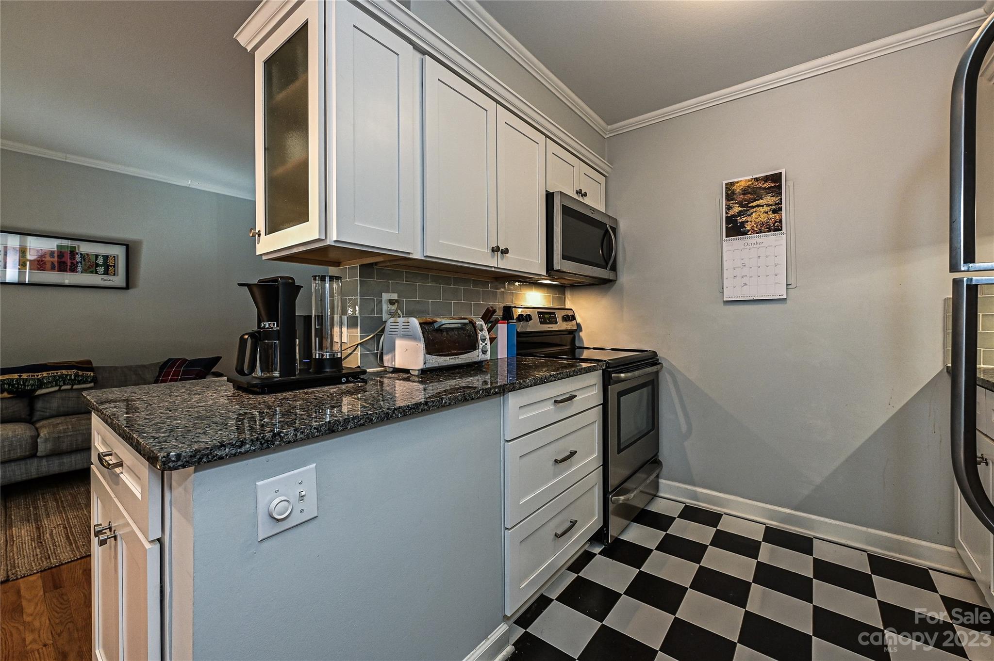 400 Queens Road, Unit B5 Charlotte, NC 28207 - Photo 10 of 20 a kitchen with stainless steel appliances granite countertop a stove a sink and a microwave