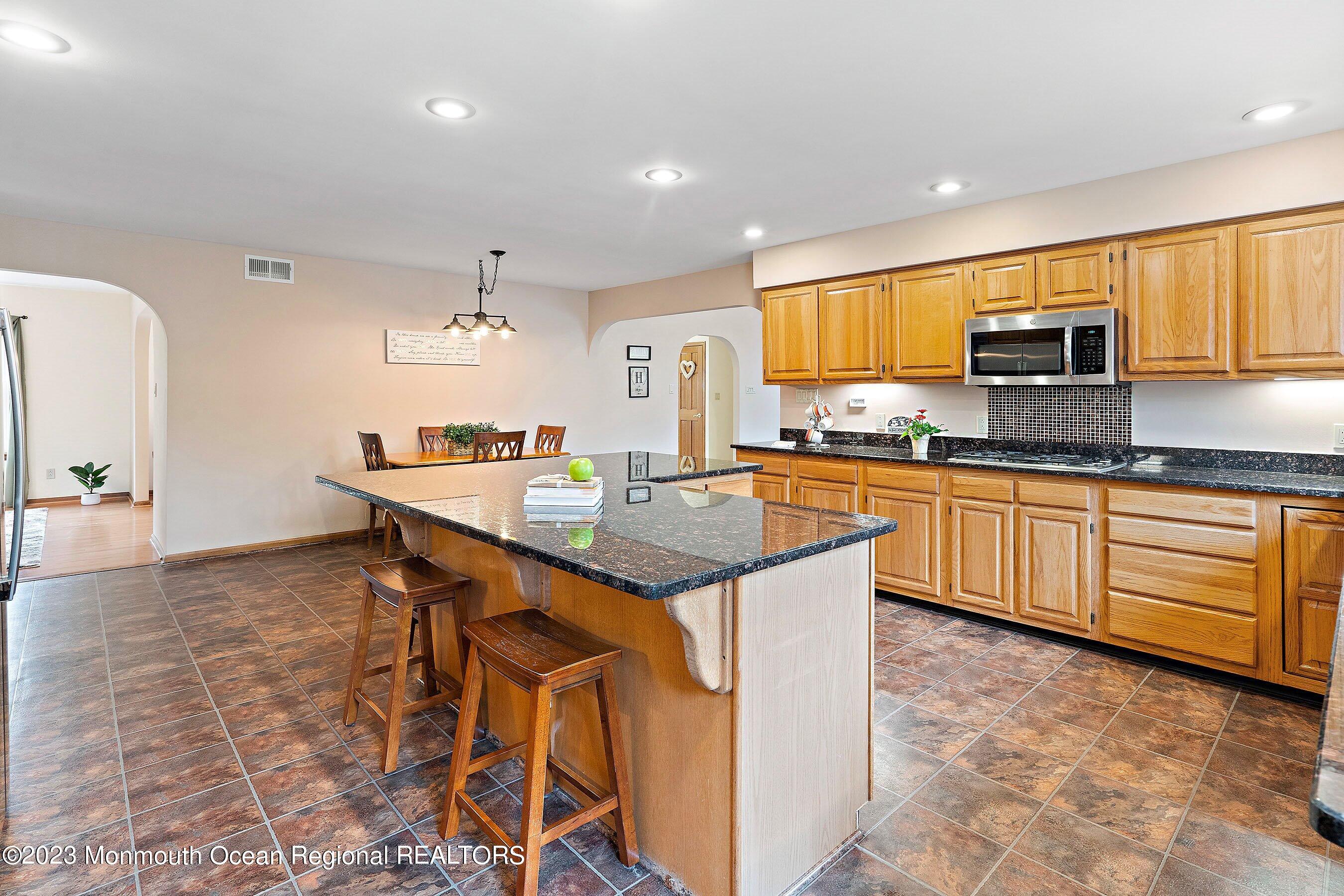 310 Easy Street Howell, NJ 07731 - Photo 13 of 45 a kitchen with kitchen island granite countertop a sink and cabinets