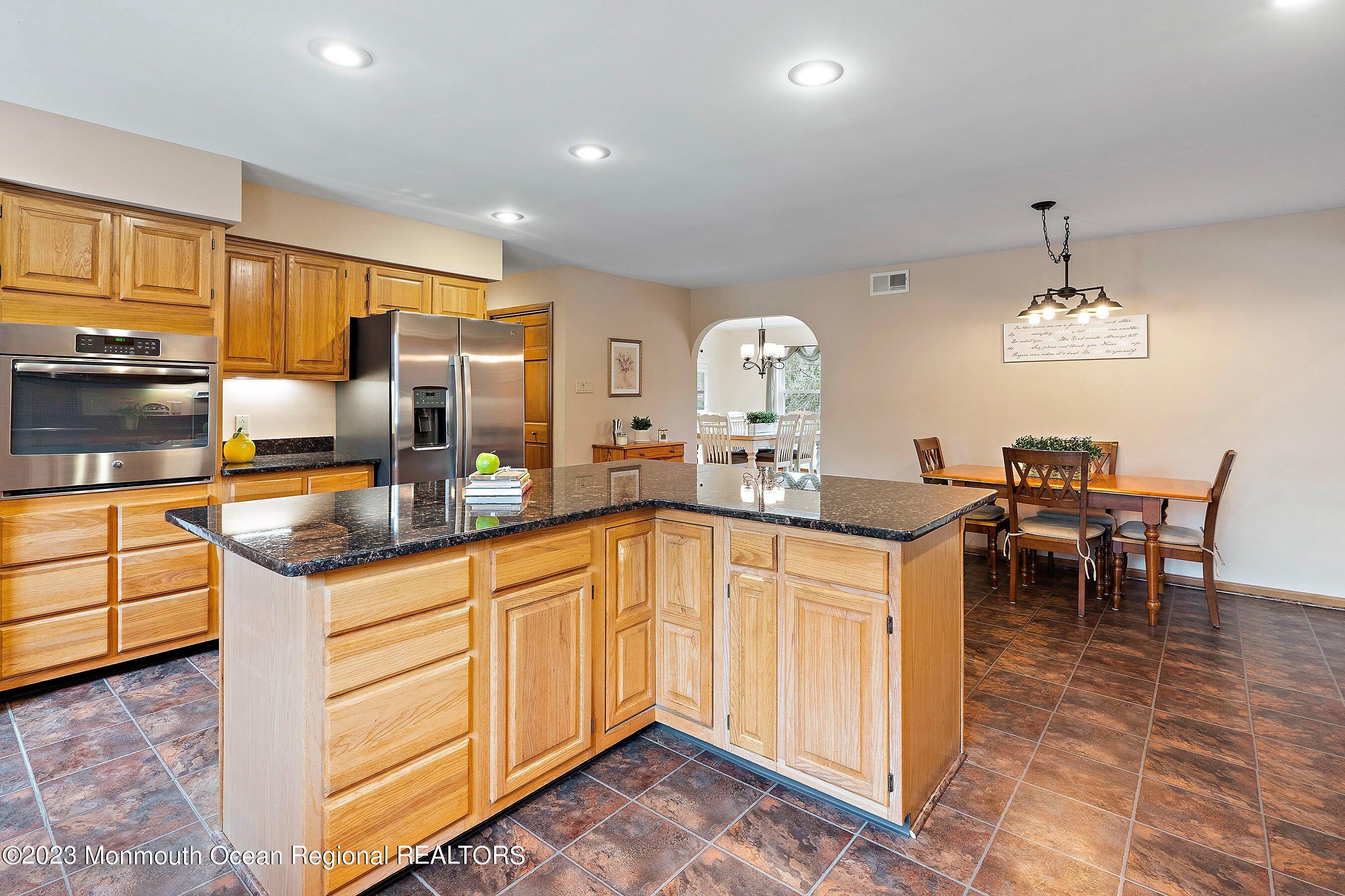 310 Easy Street Howell, NJ 07731 - Photo 14 of 45 a kitchen with granite countertop a sink cabinets and stainless steel appliances