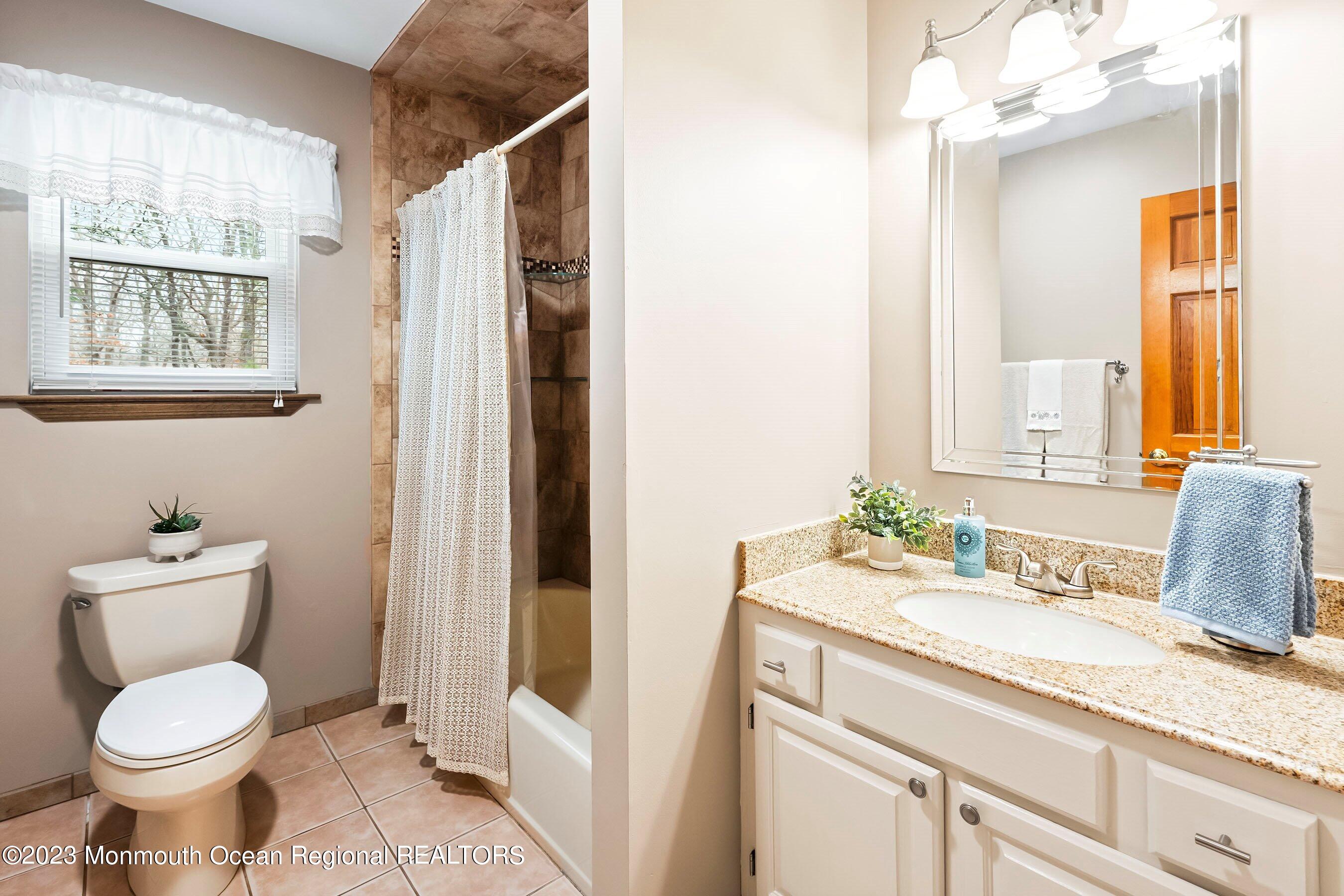 310 Easy Street Howell, NJ 07731 - Photo 24 of 45 a bathroom with a granite countertop toilet sink and mirror