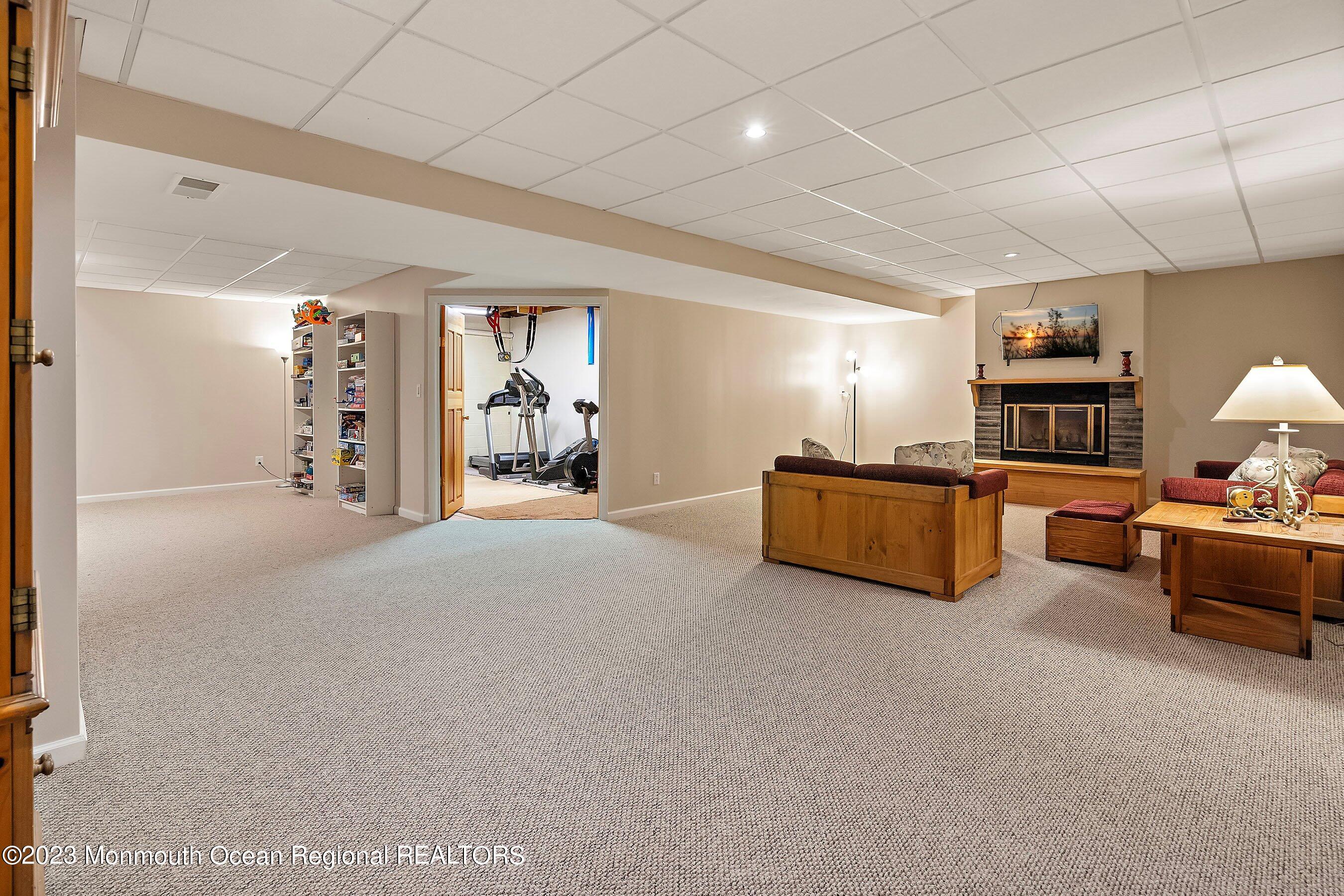 310 Easy Street Howell, NJ 07731 - Photo 27 of 45 a living room with furniture cabinets and a flat screen tv