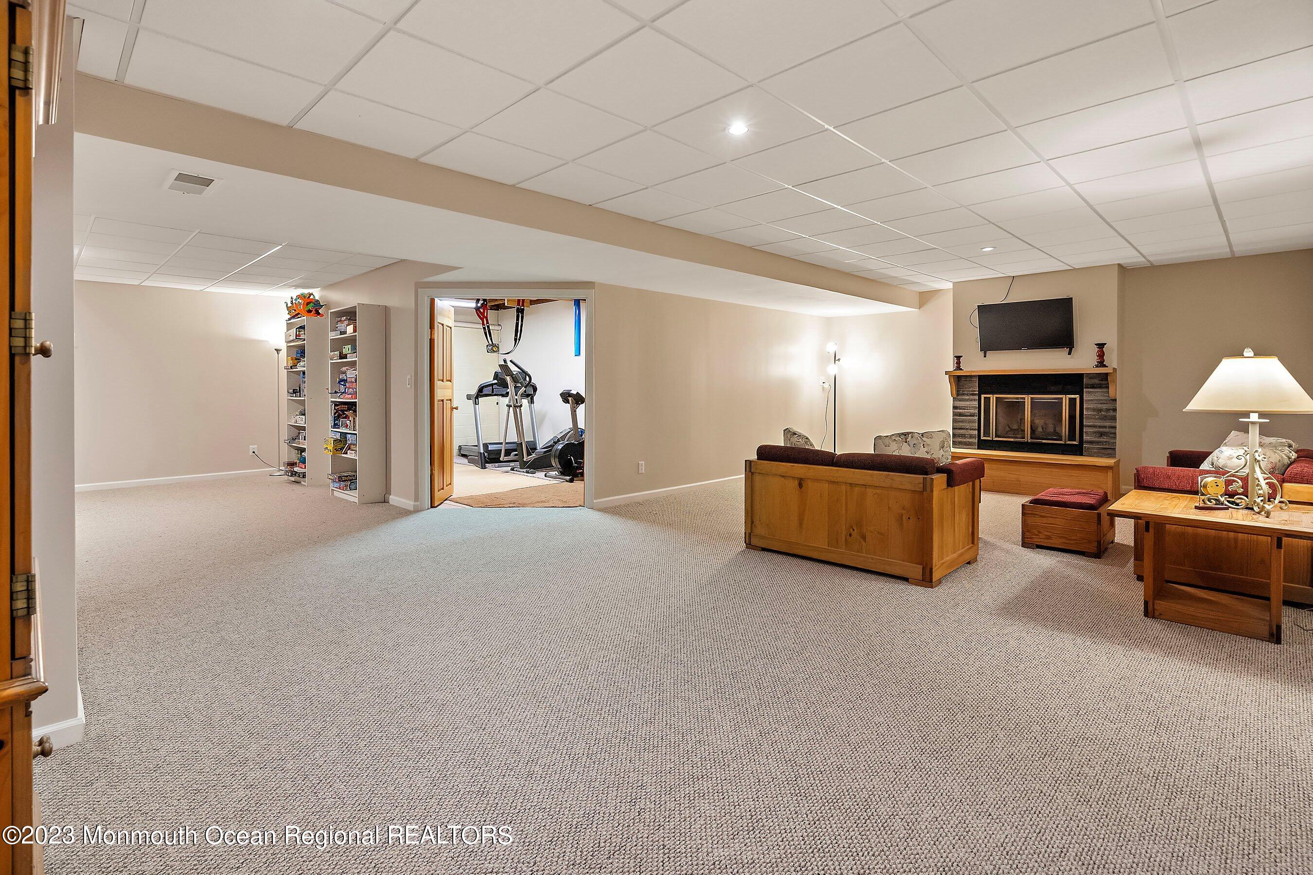 310 Easy Street Howell, NJ 07731 - Photo 28 of 45 a living room with furniture cabinets and a flat screen tv