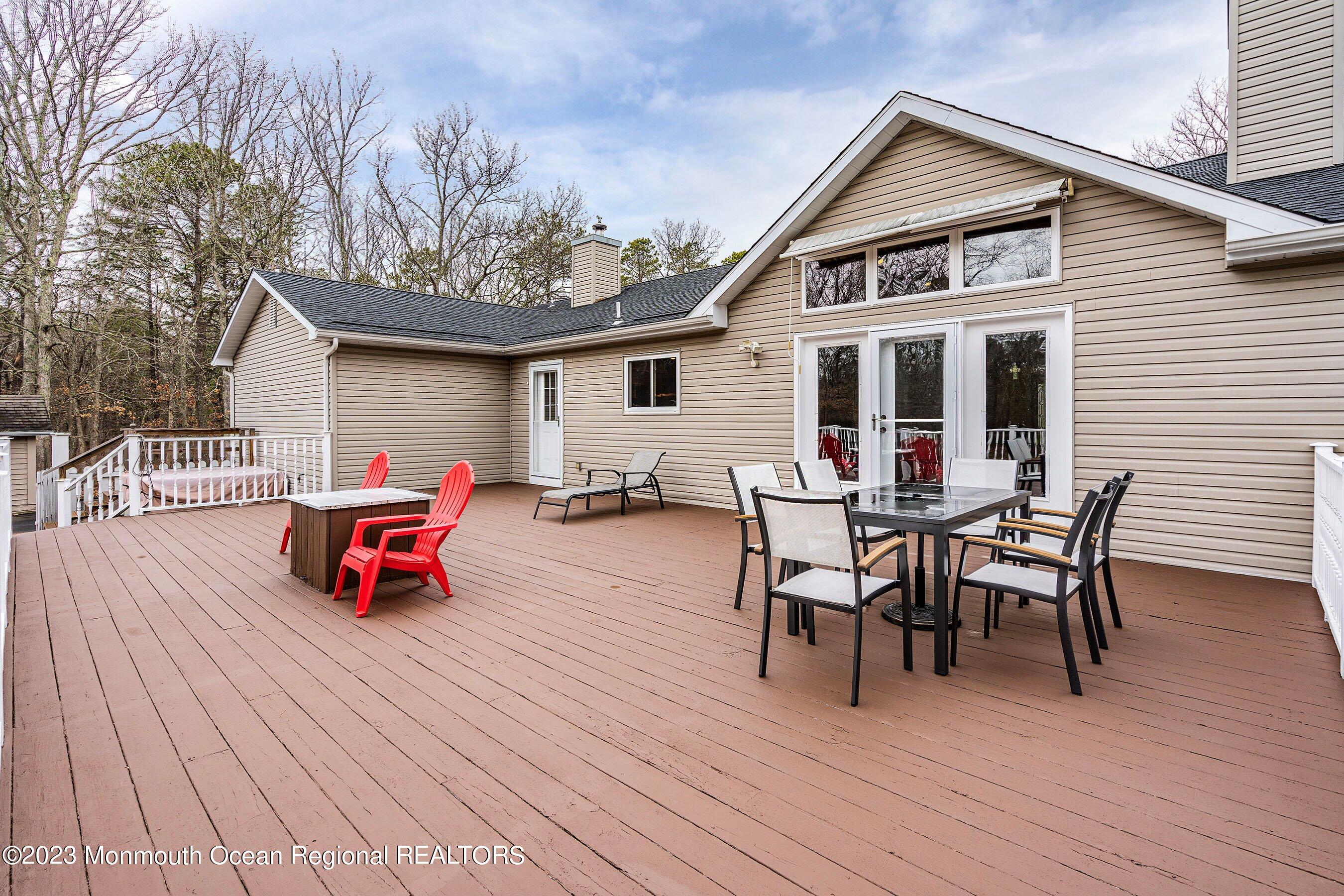 310 Easy Street Howell, NJ 07731 - Photo 31 of 45 a view of a deck with table and chairs with wooden floor and fence