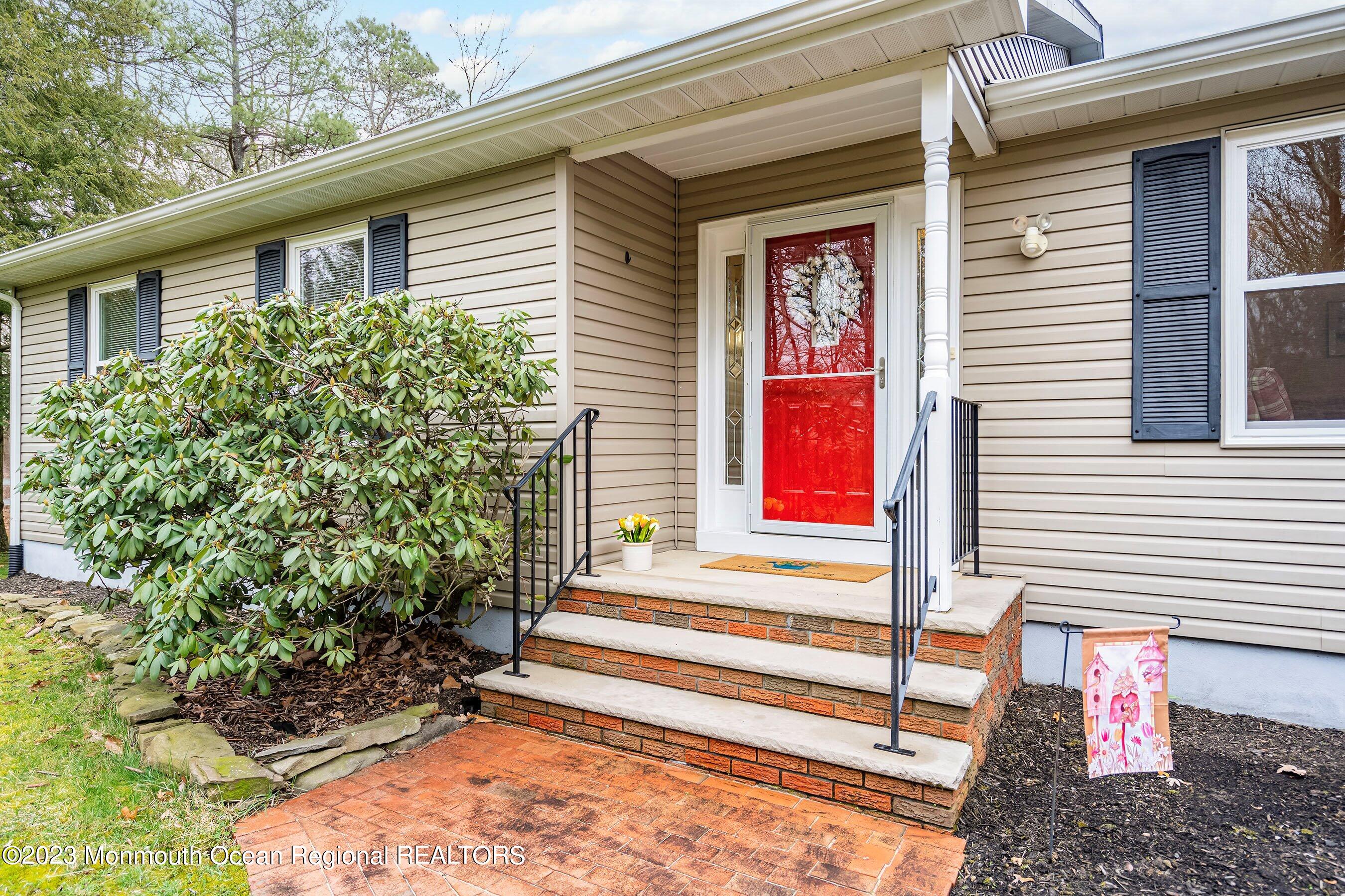310 Easy Street Howell, NJ 07731 - Photo 4 of 45 a front view of a house with a yard