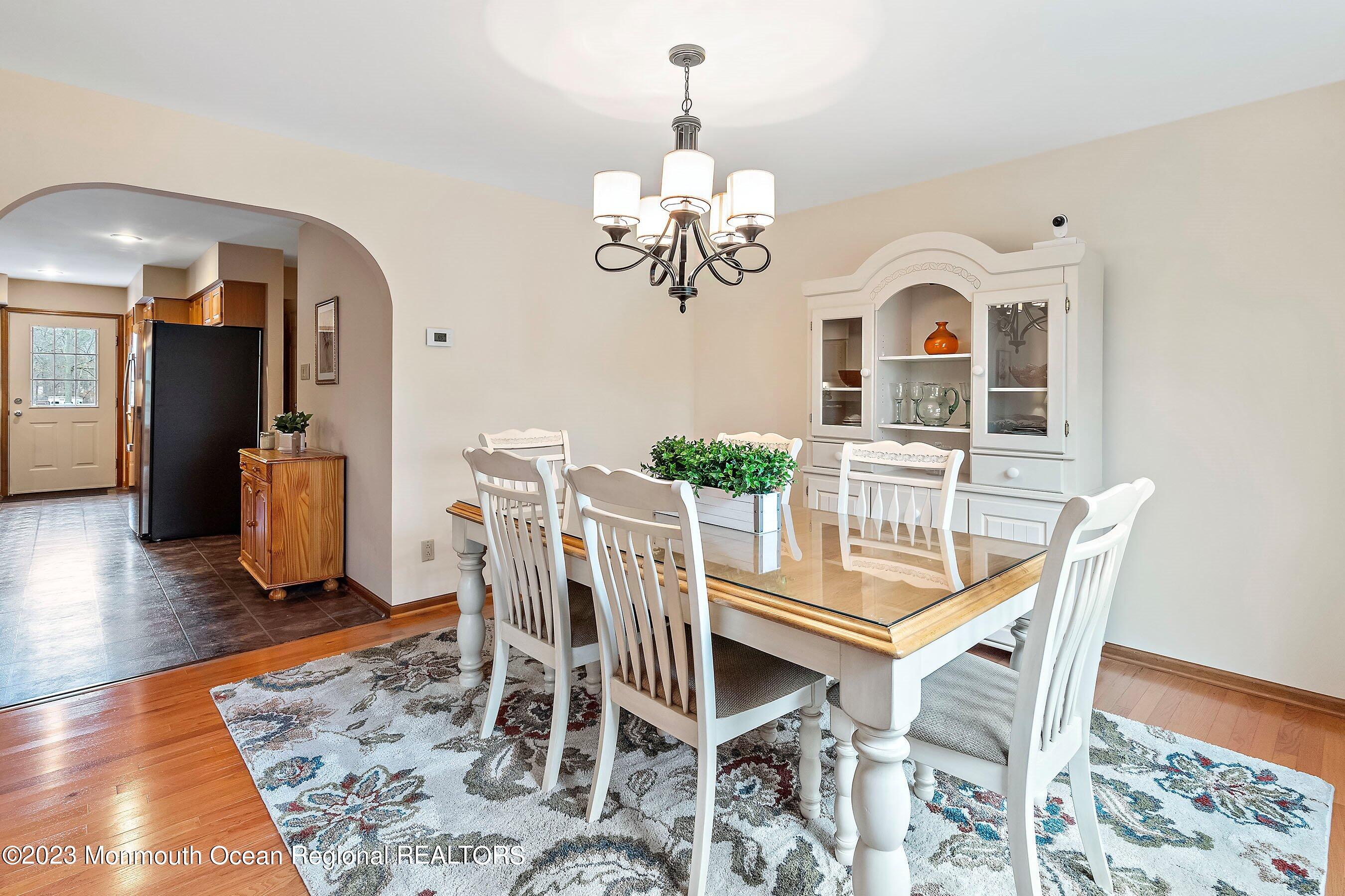 310 Easy Street Howell, NJ 07731 - Photo 10 of 45 a view of a dining room with furniture wooden floor and chandelier