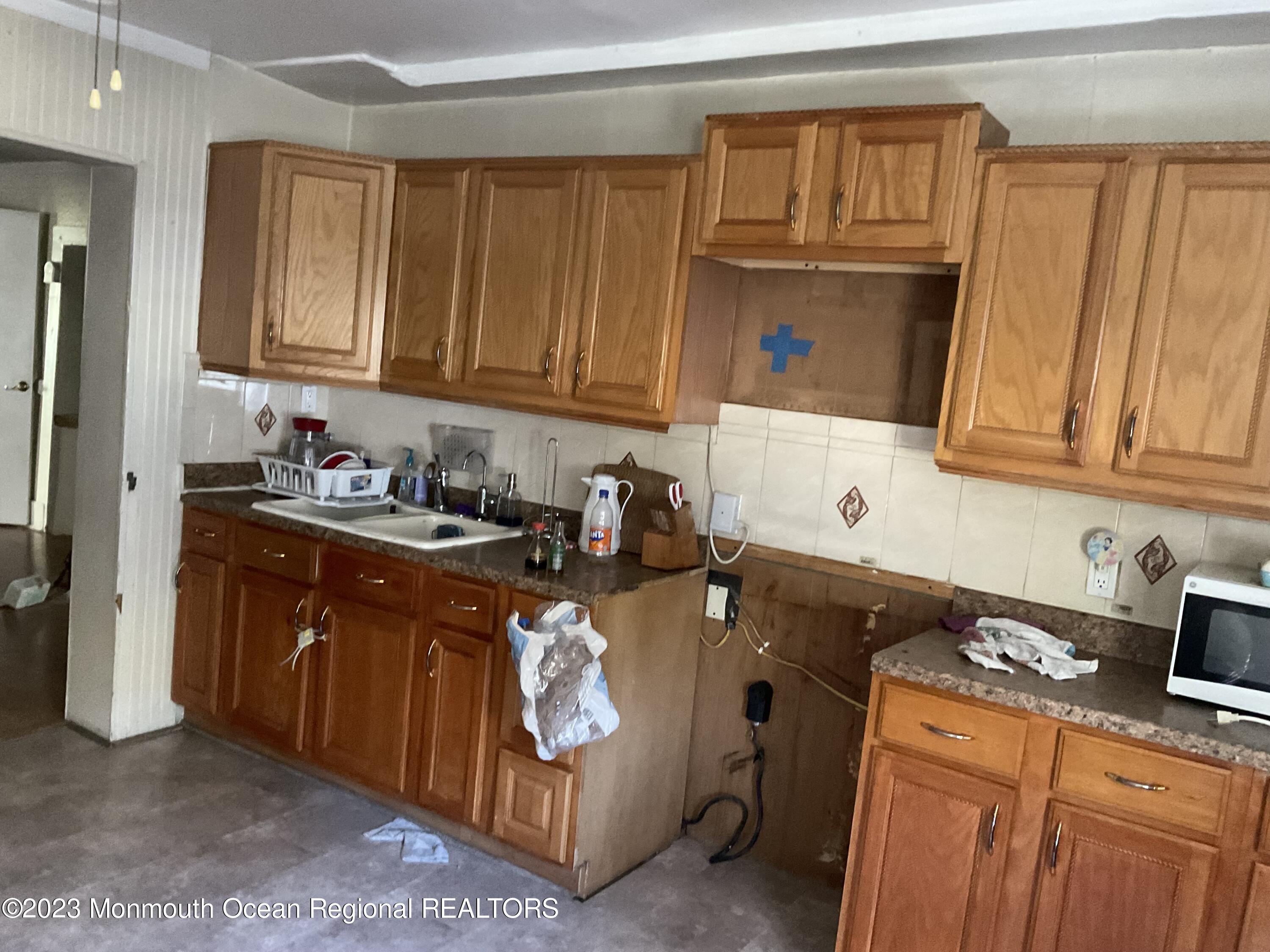 274 Ford Road Howell, NJ 07731 - Photo 16 of 16 a kitchen with stainless steel appliances granite countertop a refrigerator stove and sink