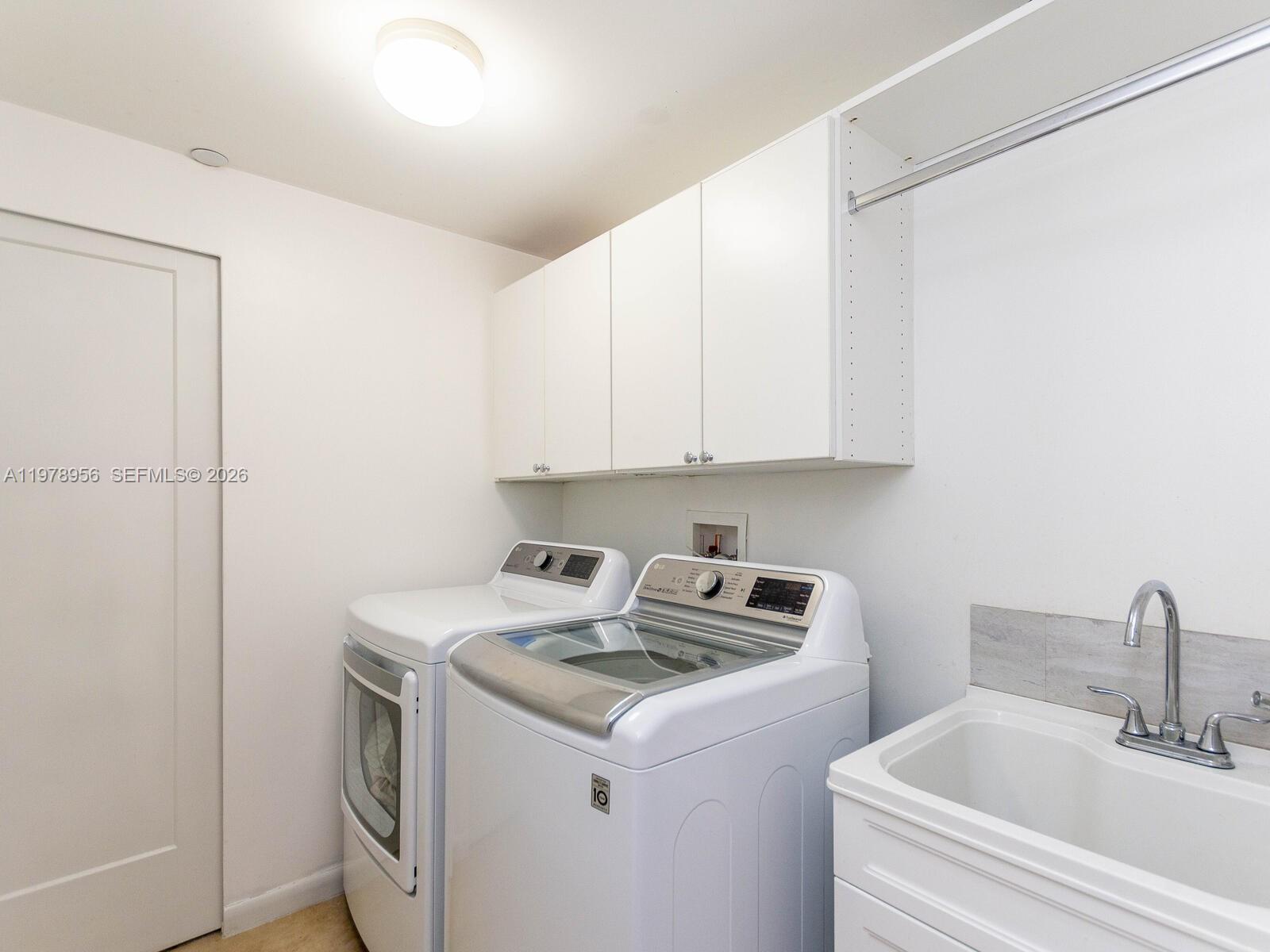 7350 Southwest 89th Street, Unit 719S Miami, FL 33156 - Photo 26 of 30 a utility room with dryer and washer