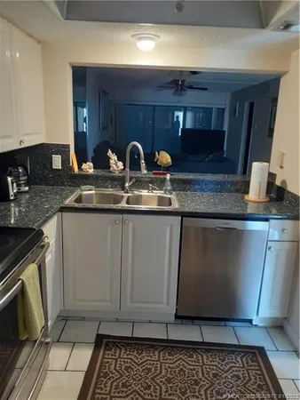 a kitchen with stainless steel appliances granite countertop a sink and a stove