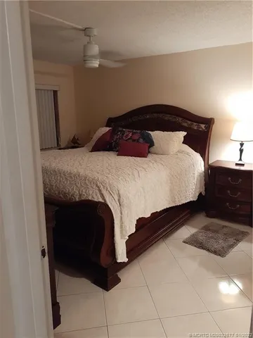 a bedroom with a bed and a potted plant