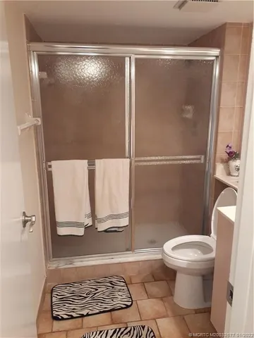 a bathroom with a toilet and a shower