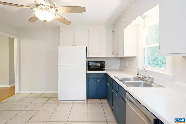 a kitchen with a sink a stove a refrigerator and cabinets