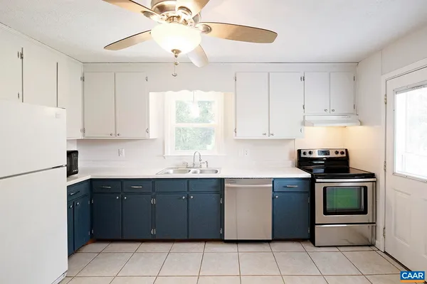 a kitchen with a sink window and cabinets
