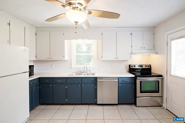 a kitchen with a sink window and cabinets