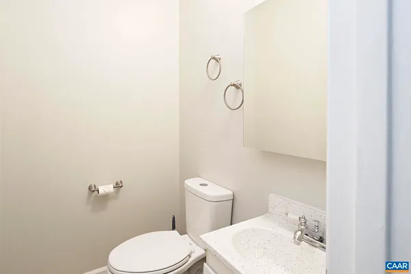 a white toilet sitting next to a bathroom sink