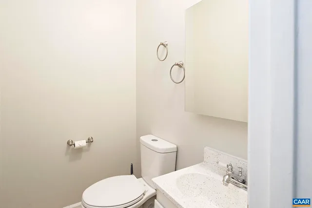 a white toilet sitting next to a bathroom sink