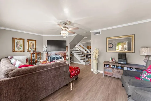 a living room with furniture and a wooden floor