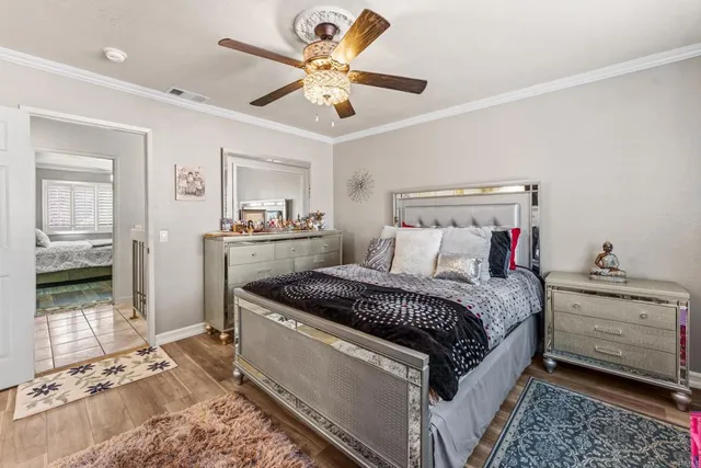 a bedroom with a bed and a chandelier