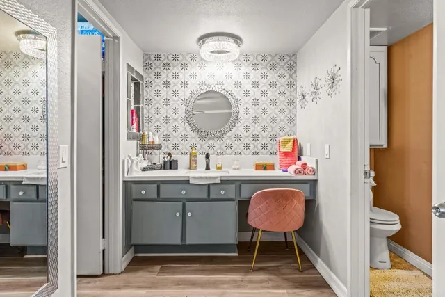a bathroom with a sink a toilet and a mirror