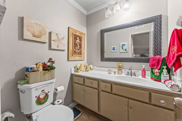 a bathroom with a sink mirror vanity and toilet