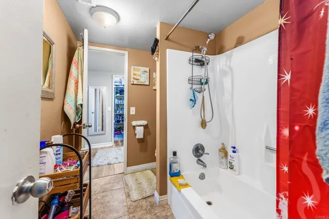 a bathroom with a tub and shower