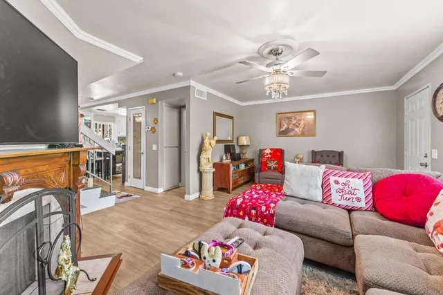 a living room with furniture and a chandelier