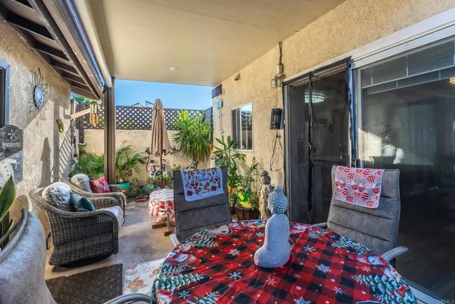 a outdoor space with the couches and a potted plant on a table