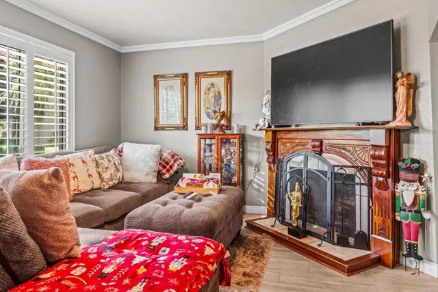 a living room with furniture a flat screen tv and a fireplace