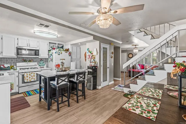 a view of a dining room with furniture wooden floor and chandelier