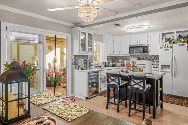 a living room with stainless steel appliances kitchen island granite countertop furniture and a dining table