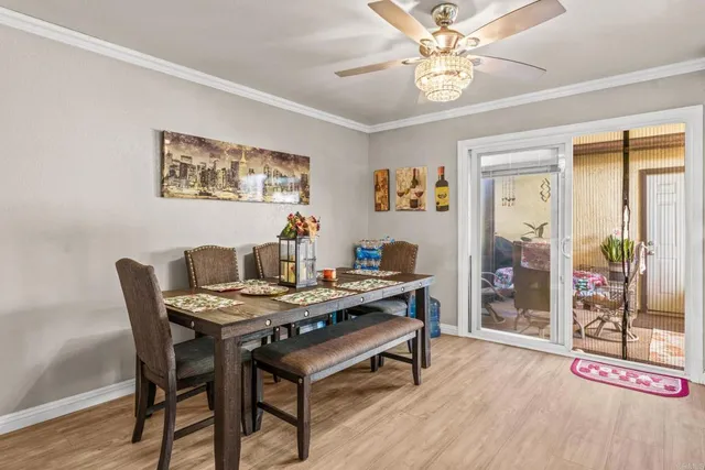 a view of a dining room with furniture and wooden floor