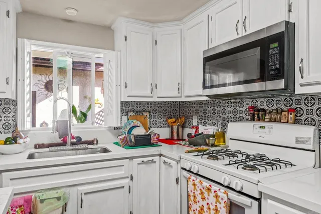 a kitchen with stainless steel appliances a stove a microwave and cabinets