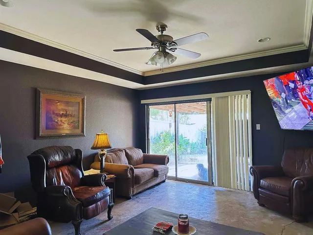 a living room with furniture and a large window