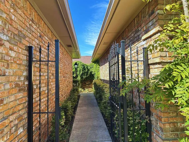 a view of a pathway along with potted plants